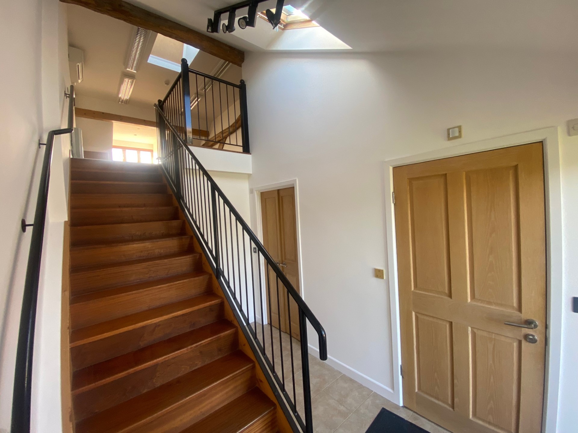 Hallway with stair and under-stair storage.